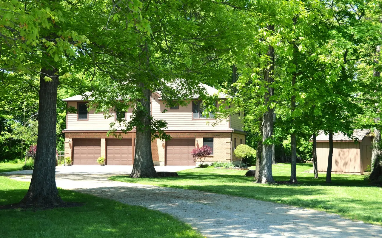 Large wooded home with a three-car garage
