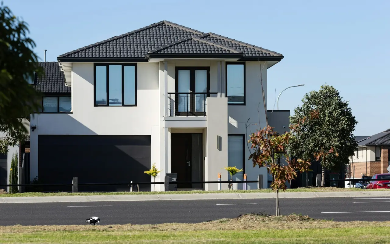 Two-story home with an attached dark sectional garage door